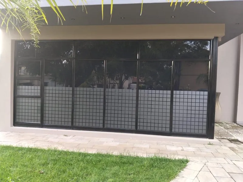 Sandton home with frosting on the lower panels and window tint above.