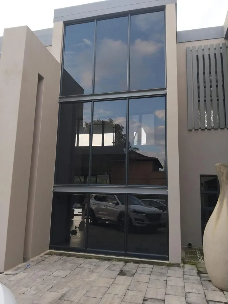 Three-storey building in Johannesburg with dark window tint.