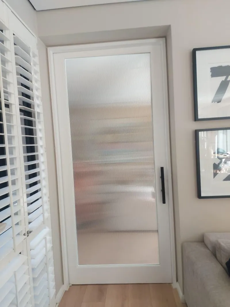 Interior door with a reeded glass effect film.